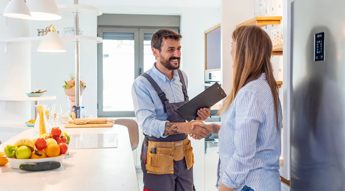 Heating service technician shaking hands with a customer