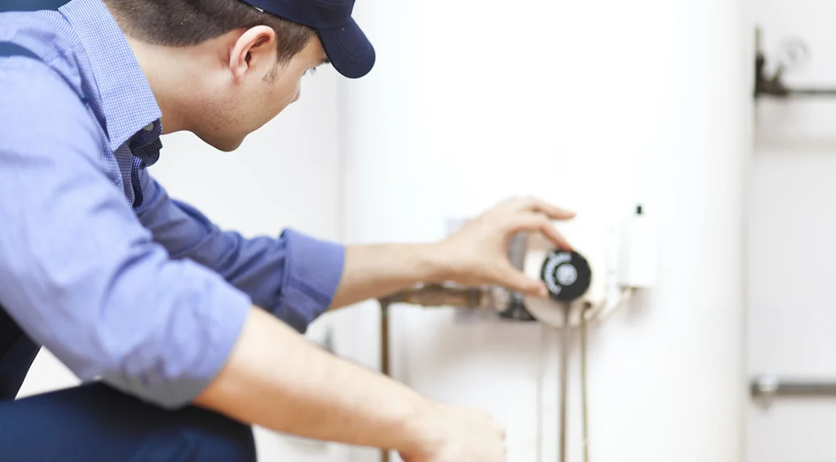 Heating technician servicing a furnace