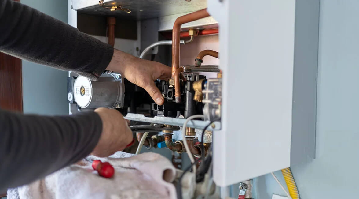 Commercial Heating Technician Repairing Unit